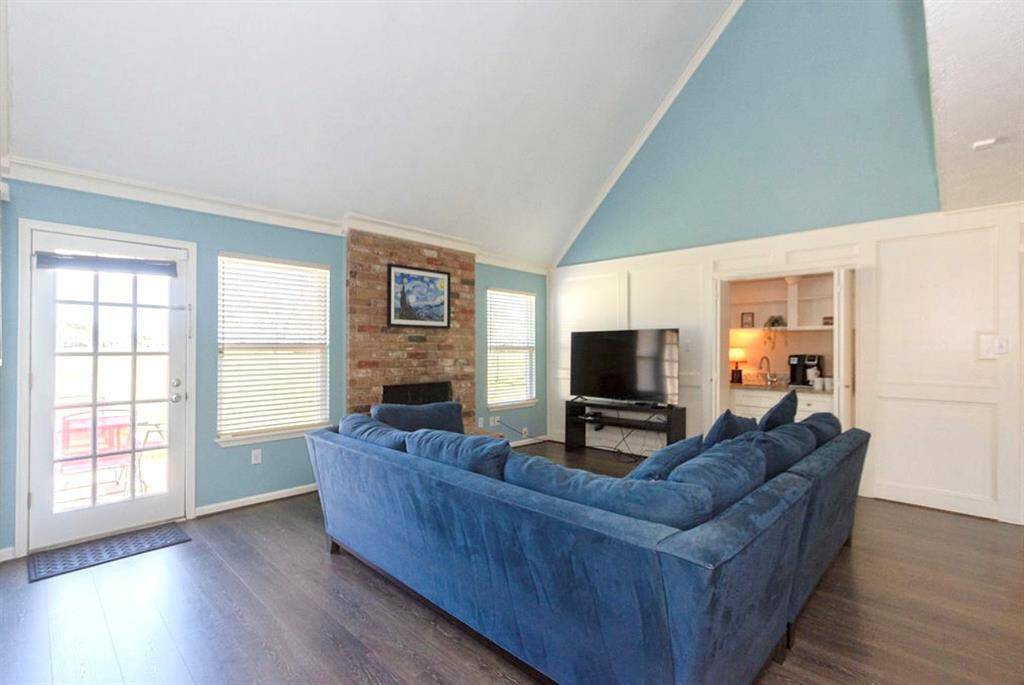The Family Room features custom painted white woodwork paneling, built-ins and access to the backyard through the French door!