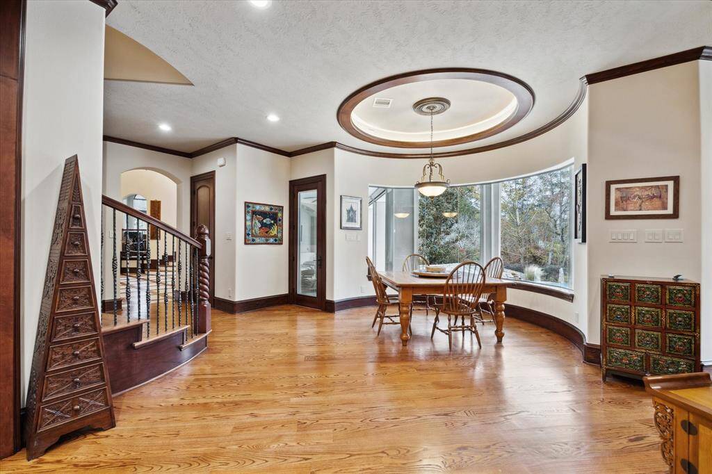 The breakfast room features a continuation of the wood flooring and a custom trayed ceiling and ideal for casual dining or entertaining