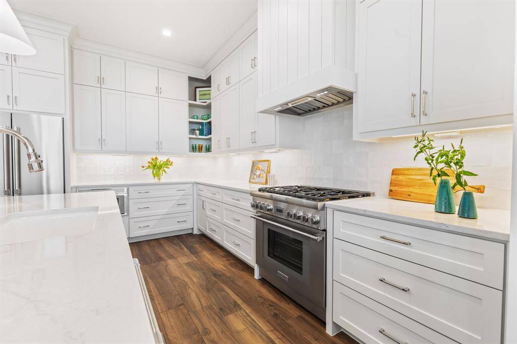Kitchen features Thermador appliances with a gas range.