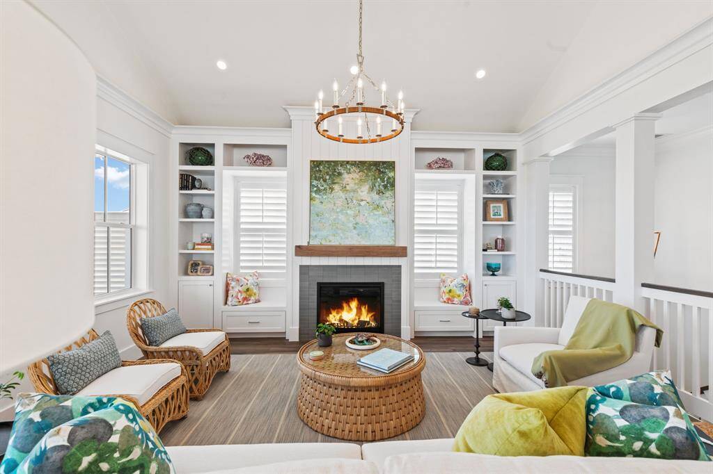 Great Room offers a fireplace, built-in cabinetry, and a tall cathedral ceiling