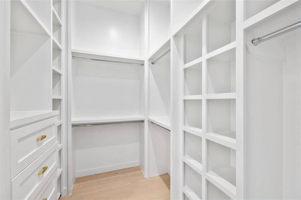 View of the 2nd primary closet that features super useful built in cabinets and storage!