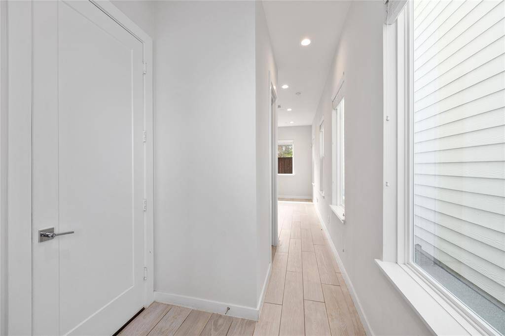 Entryway showcases tons of natural lighting from this wall of private windows.