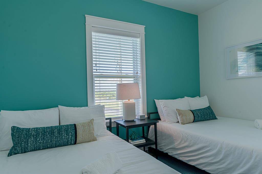 Third bedroom with ceiling fan and cased windows