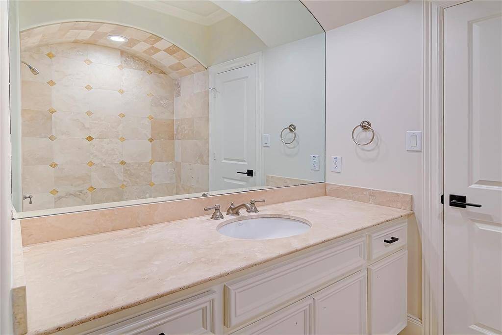 Bathroom with elegantly tiled shower.