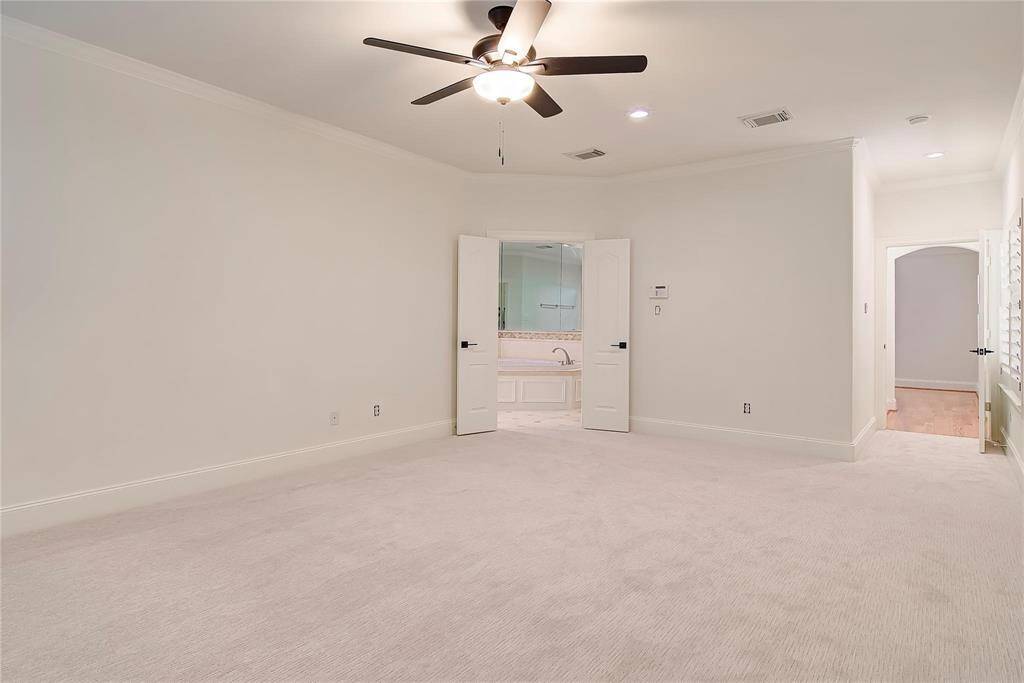 Double doors lead to elegant primary bathroom.