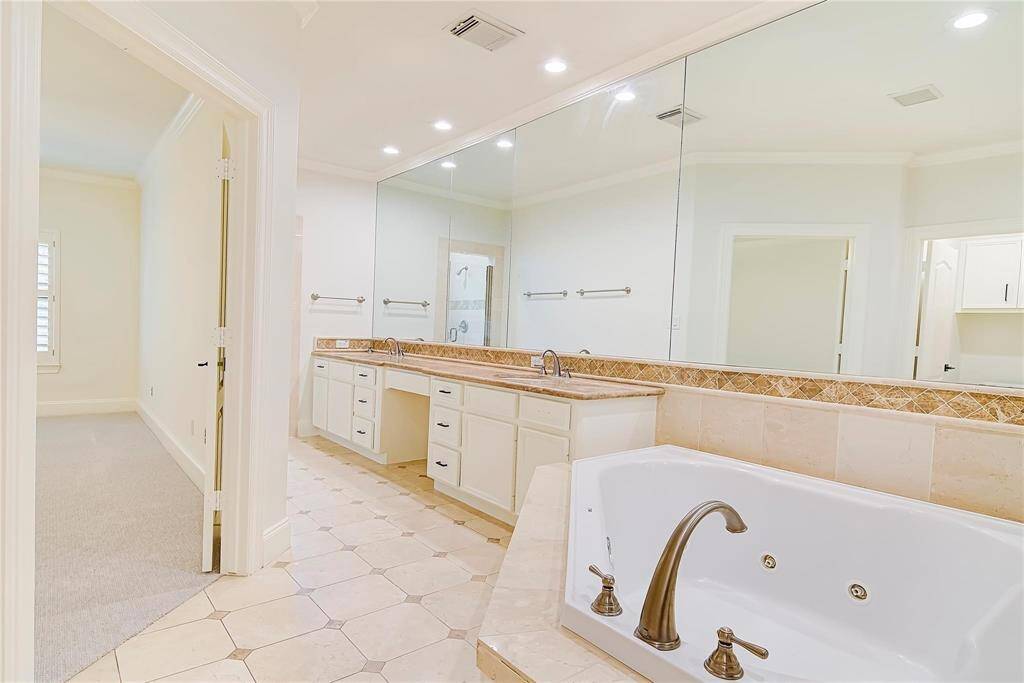 Wall to wall mirrors with a large inviting jetted tub.