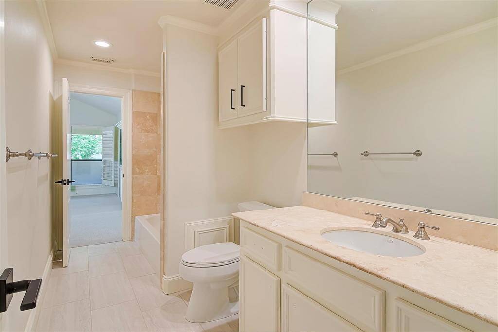 Third floor bathroom with granite countertops and new fixtures.