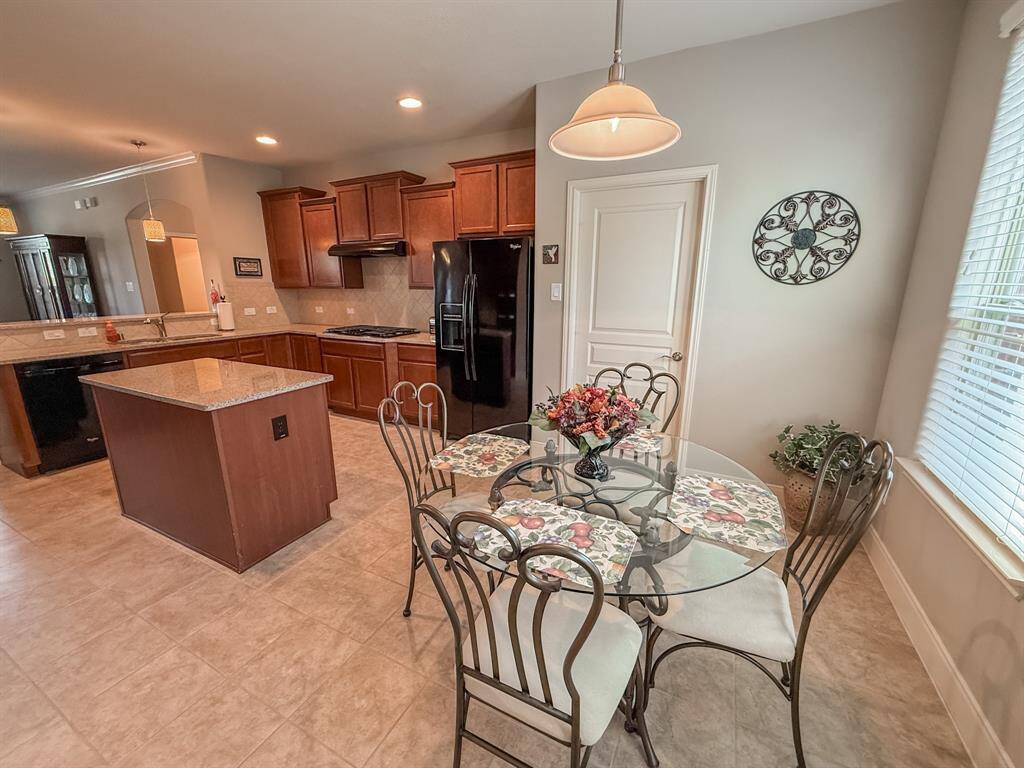 Check the size of the kitchen and breakfast area!  The natural light is wonderful, and the tile floors are beautiful.  The door leads to the laundry room and garage.