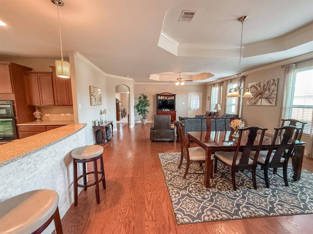 Beautiful engineered hardwood floors, trey ceilings, pretty pendulum lighting highlight this beautiful home.