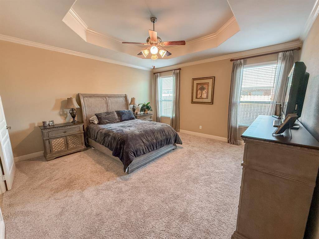 The Primary Suite has a view of the back yard, recently installed carpet, a trey ceiling and so much room for your bedroom furniture!