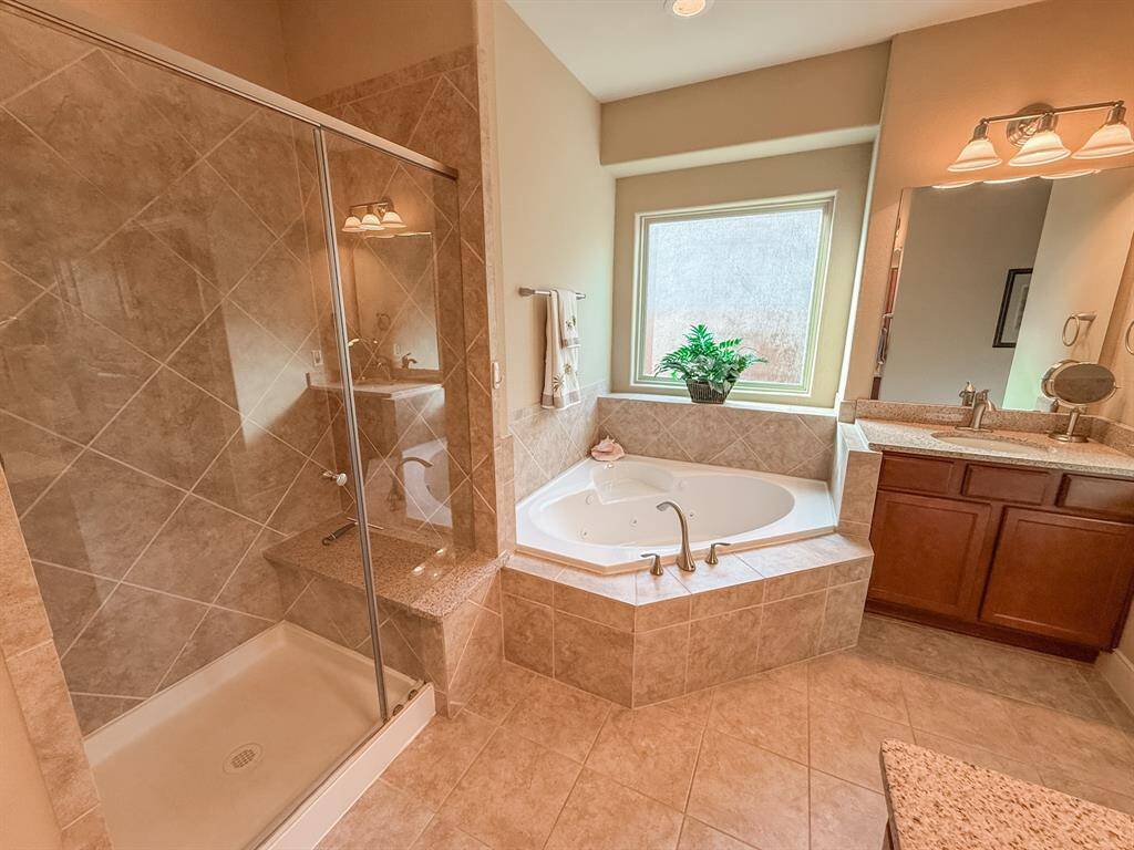 The shower has bench seating as does the tub.