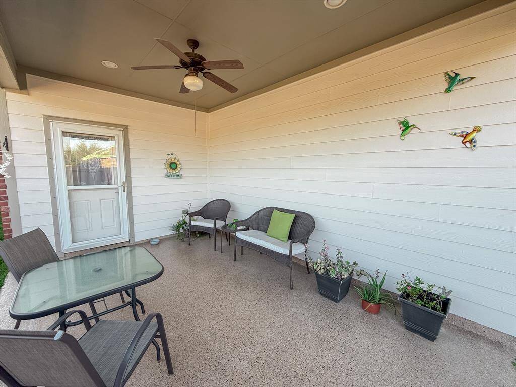 You will love relaxing in the covered patio and watching the butterflies in the flower beds that will soon be sprouting back up. Note the ceiling fan to help on our hot days and the coated floor surface!