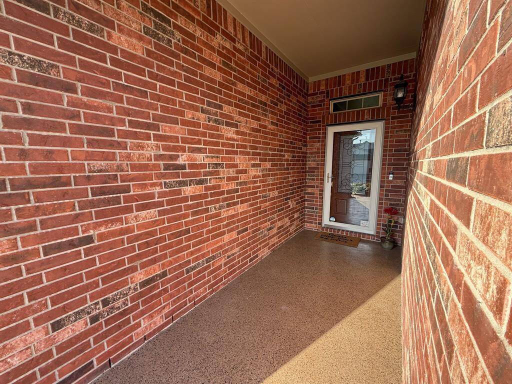 The front porch is recessed and protected, has a Ring Doorbell and the floor has an epoxy covering! Note the glass storm door and beautiful iron, glass and wood front door!
