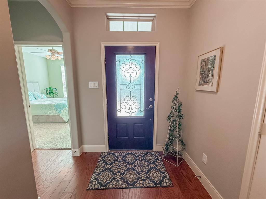 As you enter the home you are greeted with a pretty entry area and a view into the guest room at the front of the house.