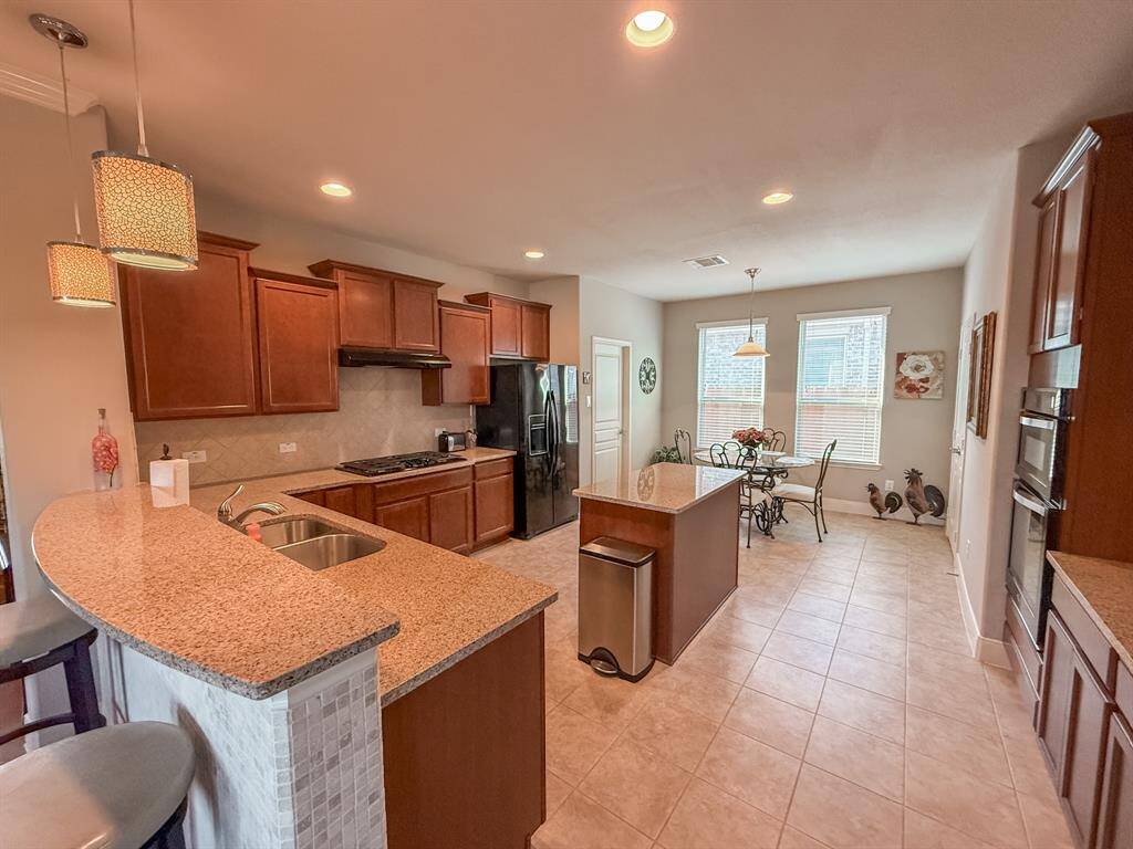 The kitchen has everything you need to prepare the perfect meals! Plenty of prep space, a larger sink, 5 burner gas stove, and an island!