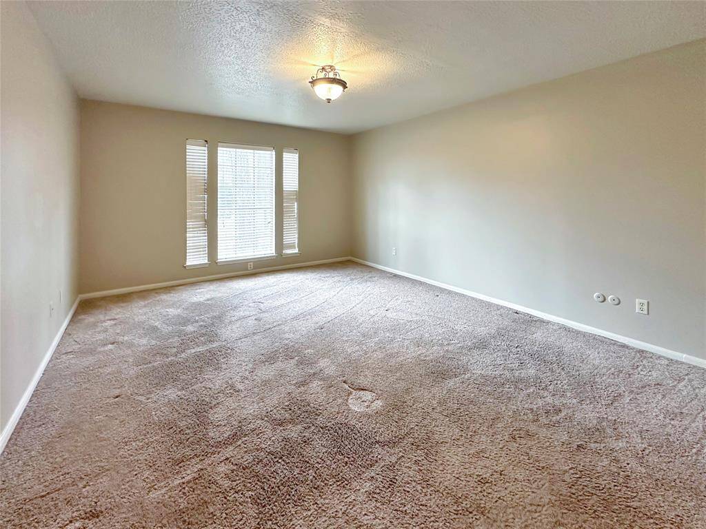 Primary bedroom is cozy and private. Located downstairs