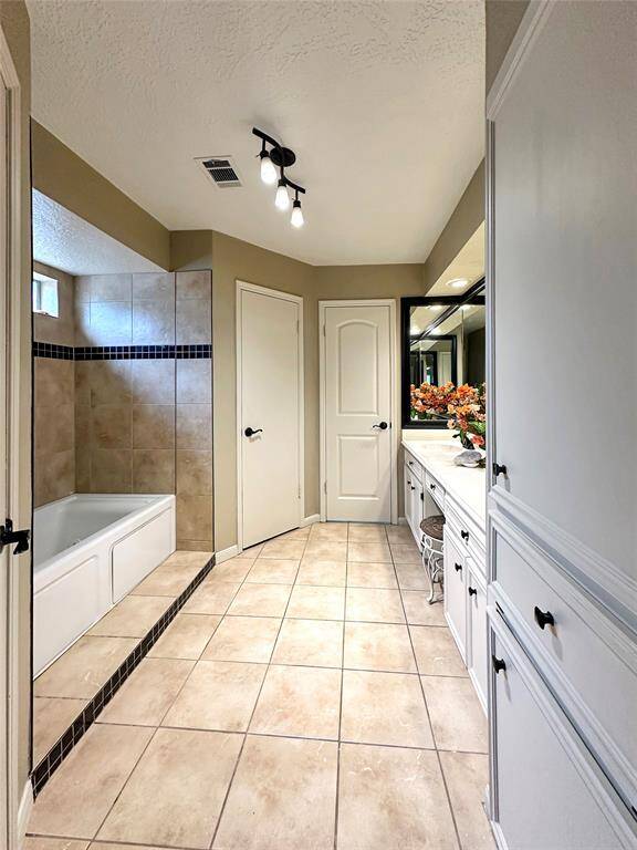 Primary restroom features dual walk-in closets and an ensuite bath.