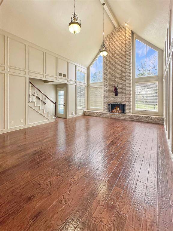The cathedral ceiling stretches high, creating an open and airy atmosphere. The soaring height enhances the feeling of space, making the room a perfect gathering spot for family and friends.