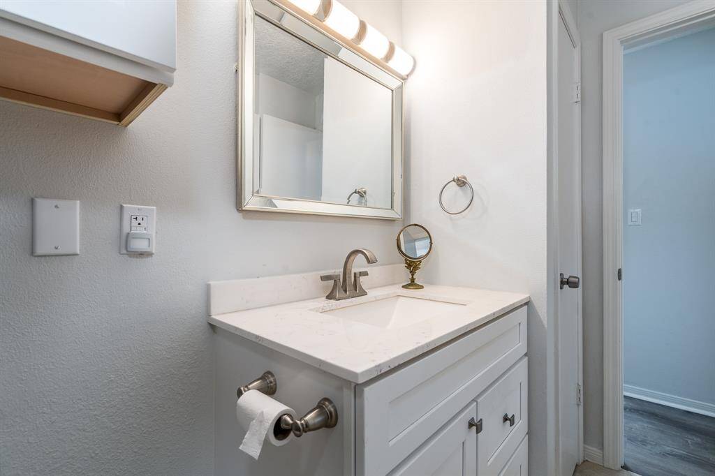 The secondary bath also has a new vanity to complement the shower.