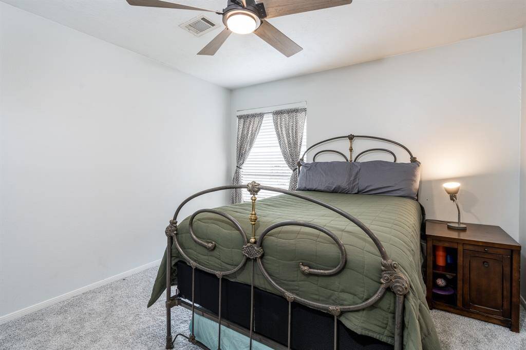 The secondary bedroom has a large window to allow natural light in and features a walk in closet.
