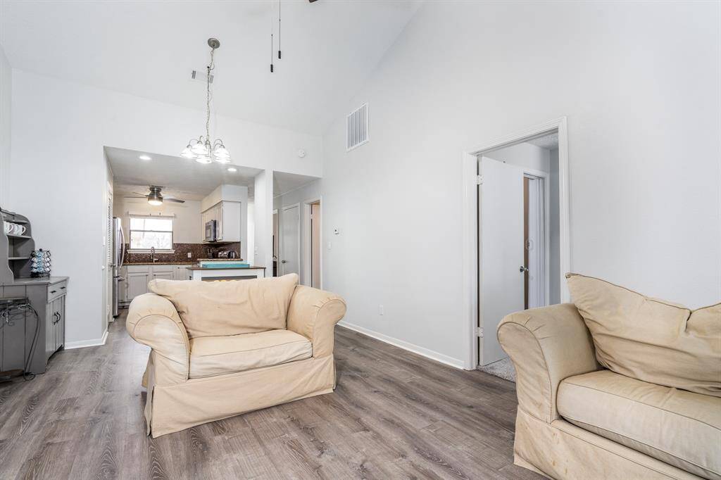 Note the high ceilings in this condominium make it feel so large and open inside.