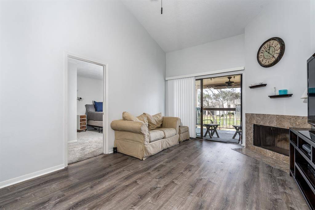 Looking towards the primary bedroom and patio. This condominium feels incredibly spacious with the high ceilings and beautiful views from your patio.