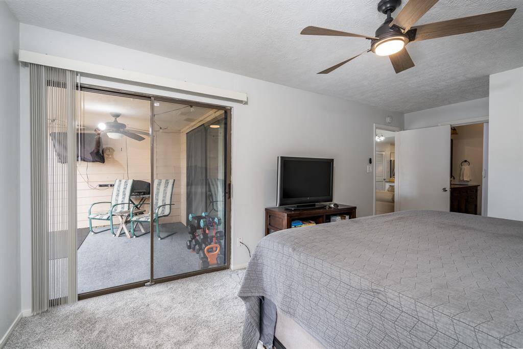 The primary bedroom has access to the private patio.  The remodeled bathroom is to the right.  There is also a walk in closet.