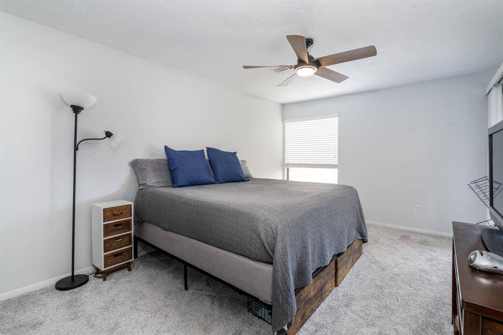 The primary bedroom with it's neutral carpet and paint.