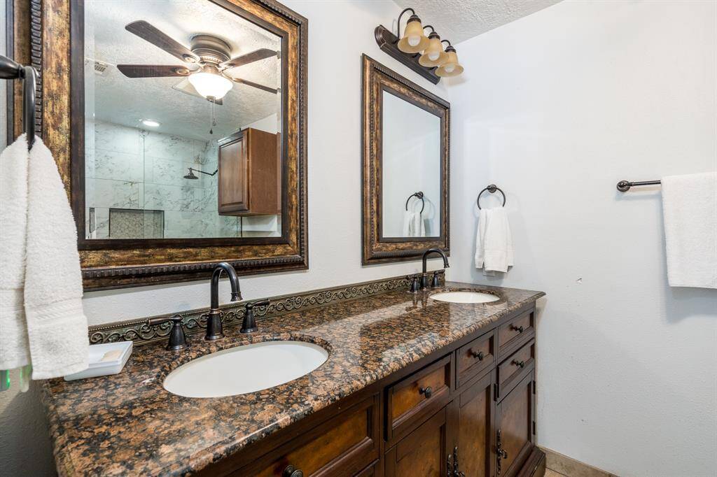 The primary bathroom has dual sinks set into a lovely vanity with dual mirrors as well.