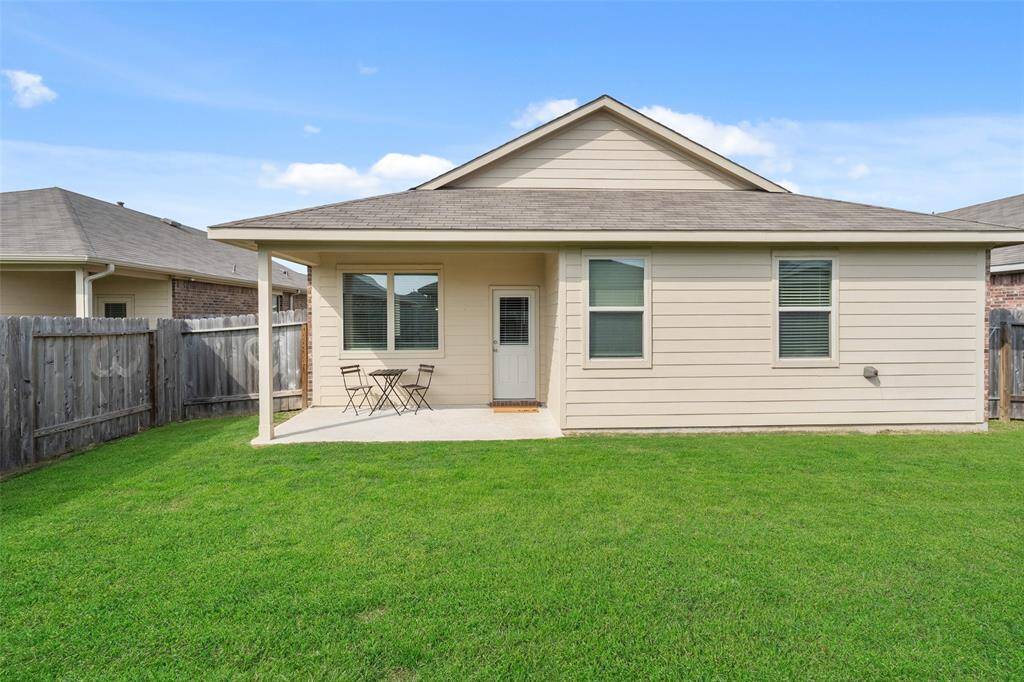 Enjoy the peace and privacy of the backyard, complete with a covered patio.