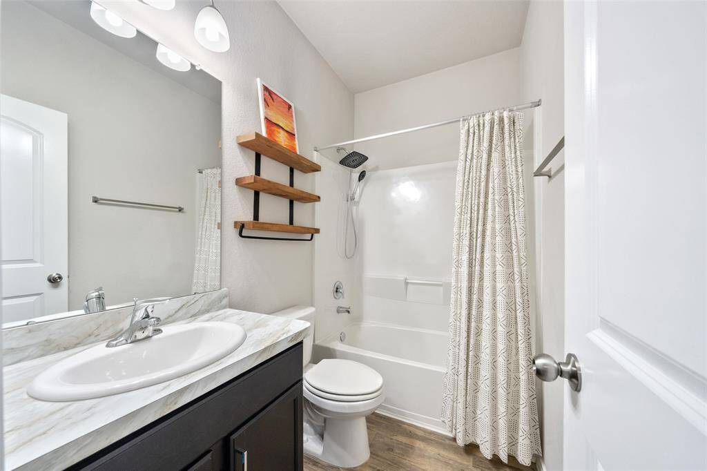 The 2 additional bedrooms share a full bathroom, thoughtfully located in the center of the home for easy access.