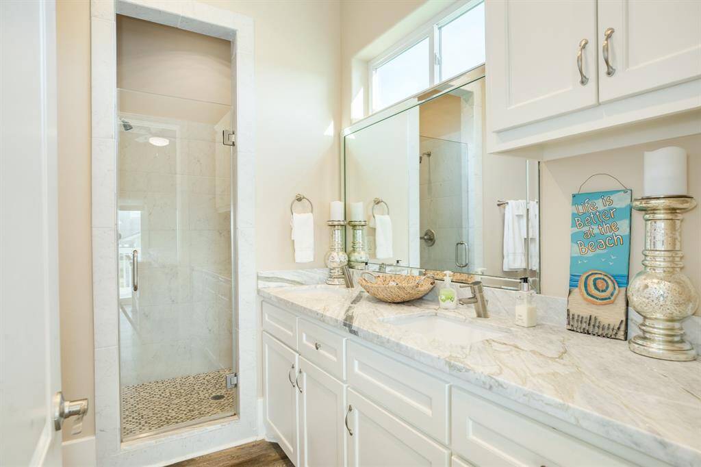 The primary en suite bathroom is luxurious and filled with natural light.