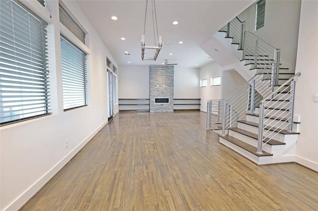 Enjoy a breathtaking view from the dining room, overlooking the elegant living area and the sleek frameless staircase, creating a seamless and modern open-concept design.