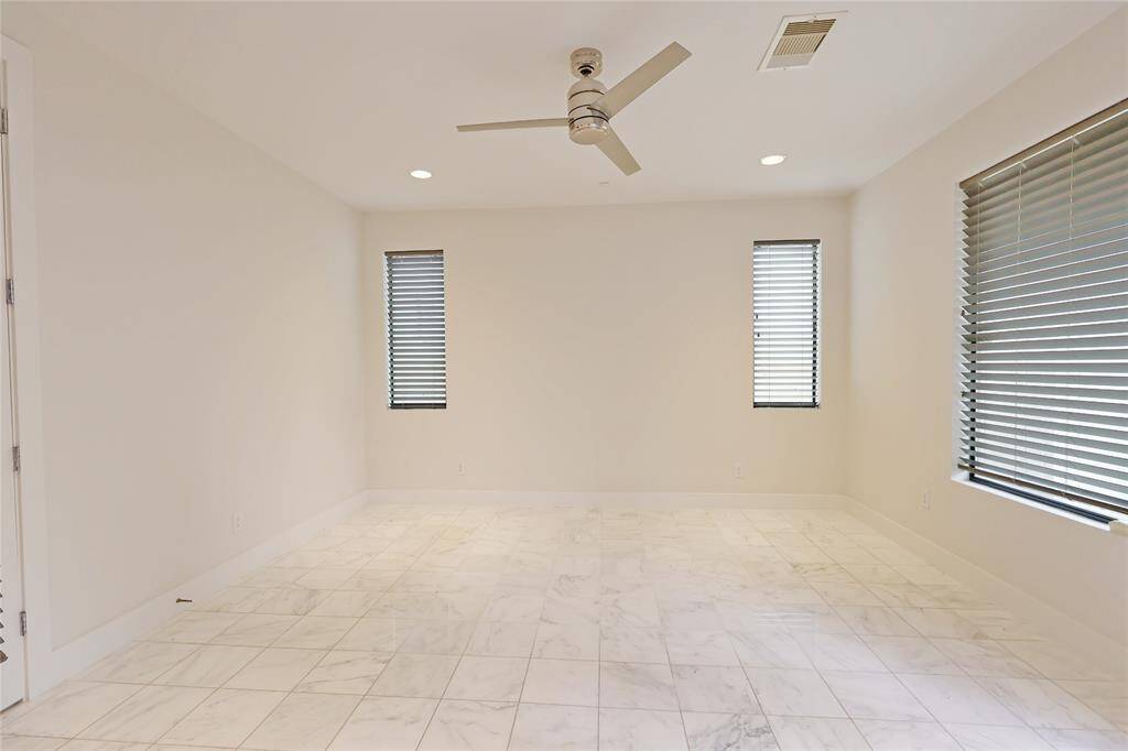 The first-floor ensuite bedroom offers privacy and convenience, with direct access to the backdoor leading to the rear and side yard—perfect for easy outdoor enjoyment.