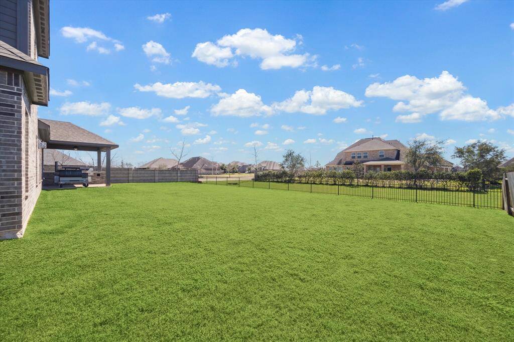 Overlooking a neighborhood green space gives this yard an even bigger feel!