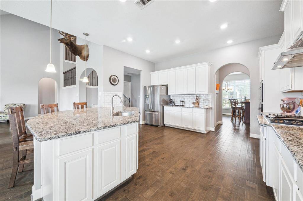 You'll love to entertain friends and family with the oversized island accented by pendant lighting!