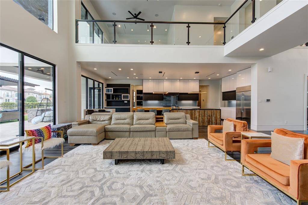 UPGRADED FAMILY ROOM WITH CUSTOM BUILT-INS, 10' ELECTRIC FIREPLACE, CHANDELIER & WESTERN SLIDING DOORS