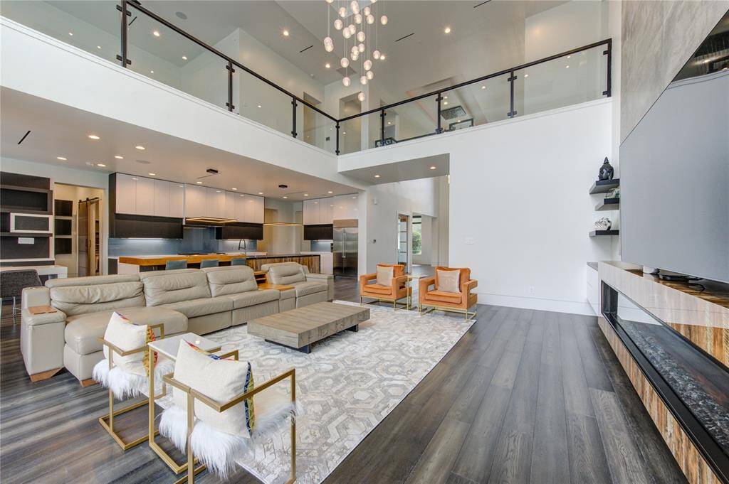 UPGRADED FAMILY ROOM WITH CUSTOM BUILT-INS, 10' ELECTRIC FIREPLACE, CHANDELIER & WESTERN SLIDING DOORS