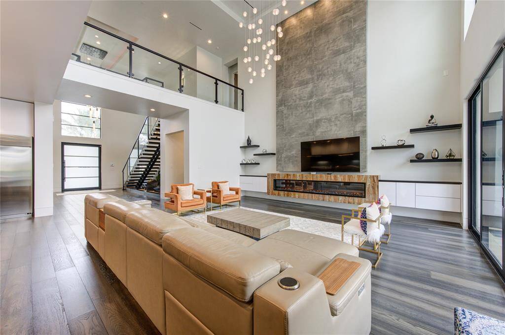 UPGRADED FAMILY ROOM WITH CUSTOM BUILT-INS, 10' ELECTRIC FIREPLACE, CHANDELIER & WESTERN SLIDING DOORS