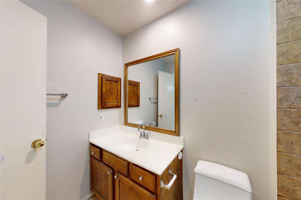 Vanity of the secondary bath. Note the built-in medicine cabinet .