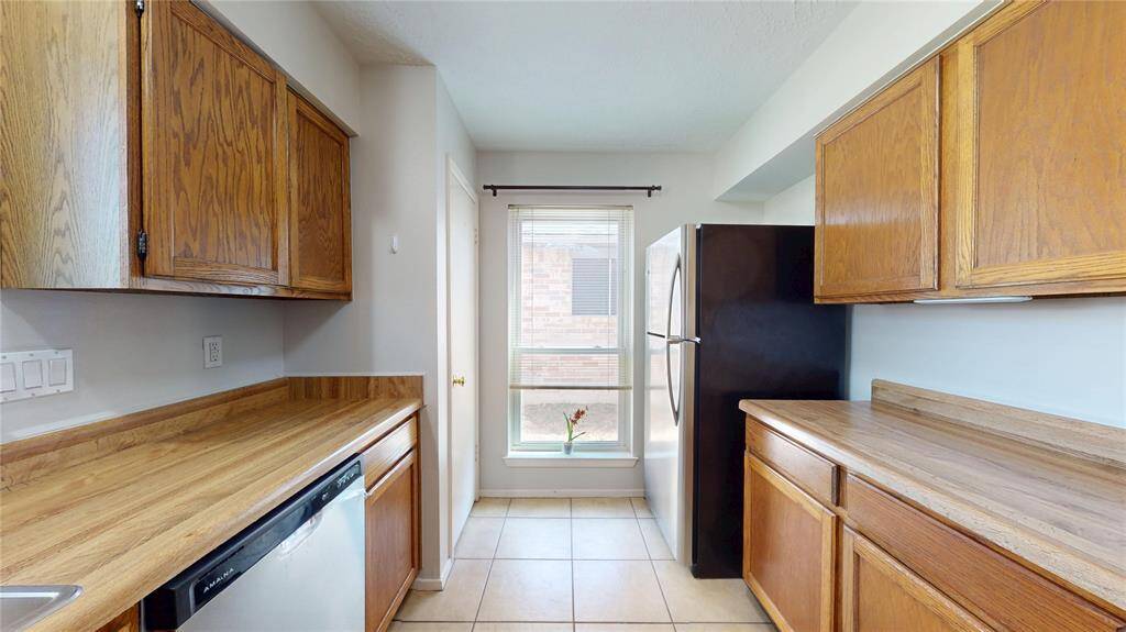 Looking through the kitchen - Pantry door on the left and fridge on the right.  The refrigerator, washer and dryer are all included.
