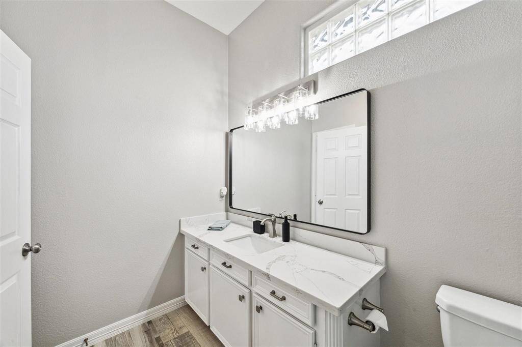 Updated bathroom featuring elegant quartz countertops and modern finishes.