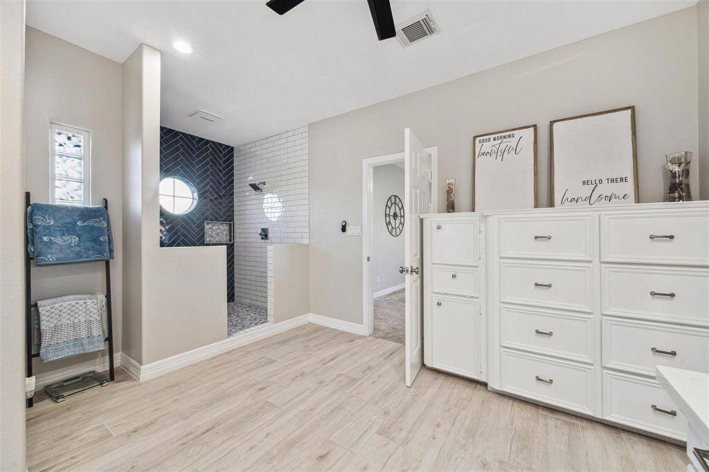 Spacious primary bathroom with generous built-in storage.