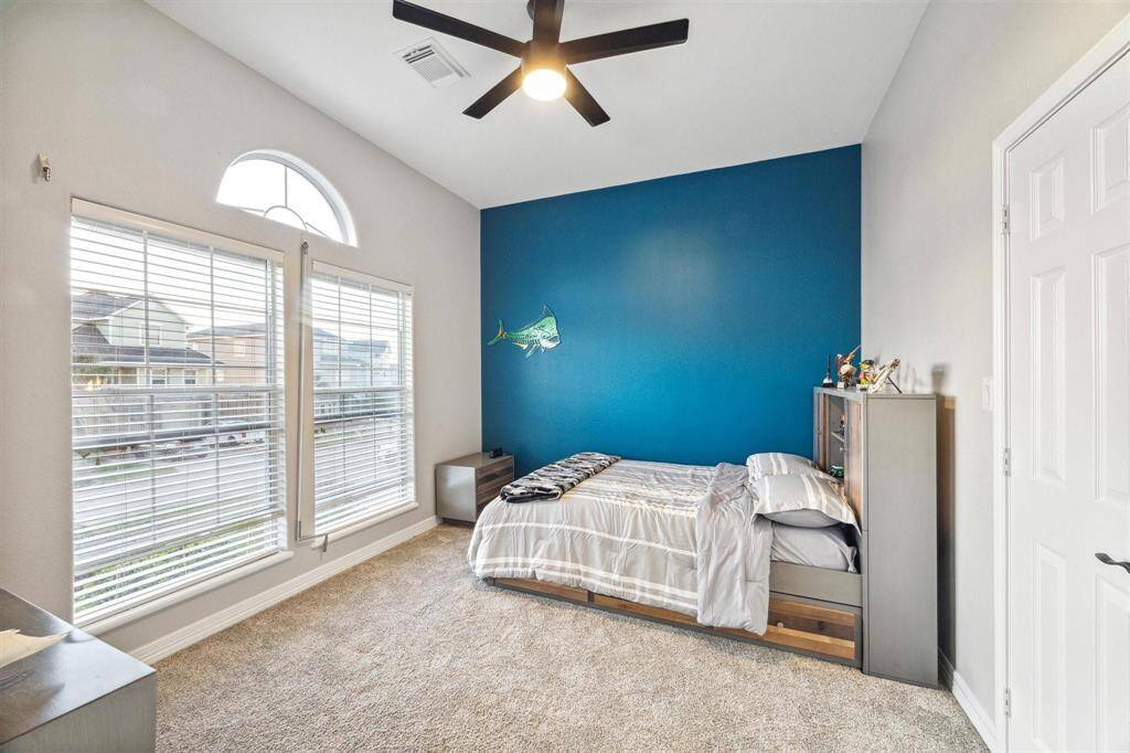 Spacious and inviting guest room with ample natural light.