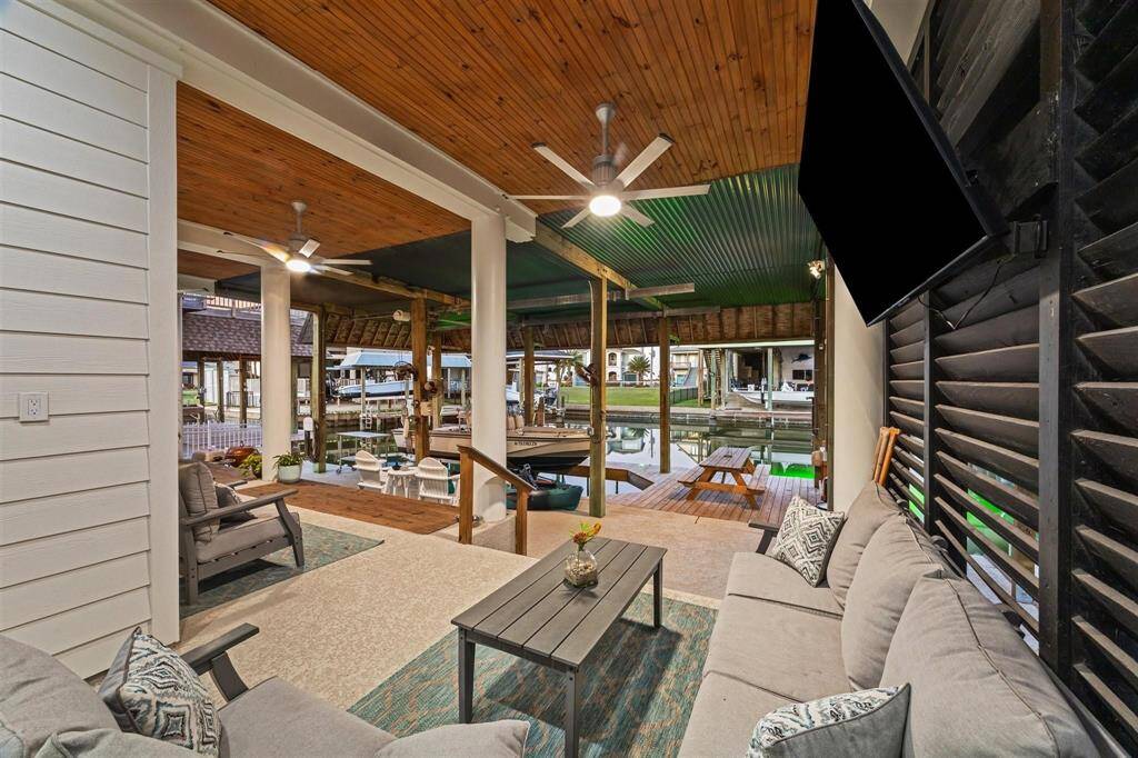 Experience the warmth and elegance of the seamless tongue-and-groove wood ceiling that adorns the expansive outdoor living space.