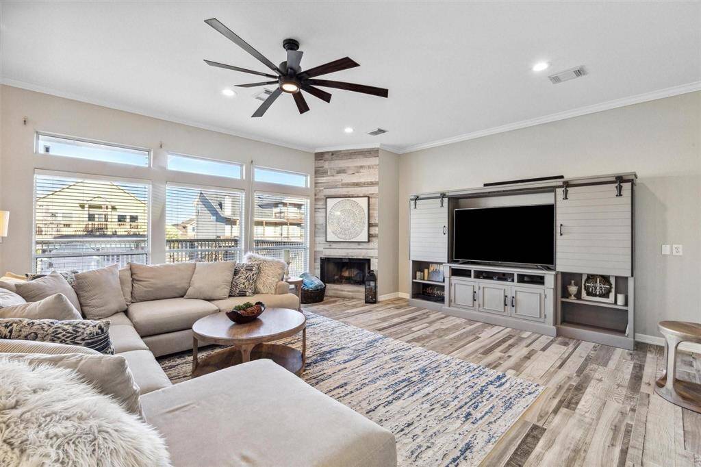 Cozy up by the inviting wood burning fireplace in this spacious and airy living room, perfect for relaxation and entertainment.