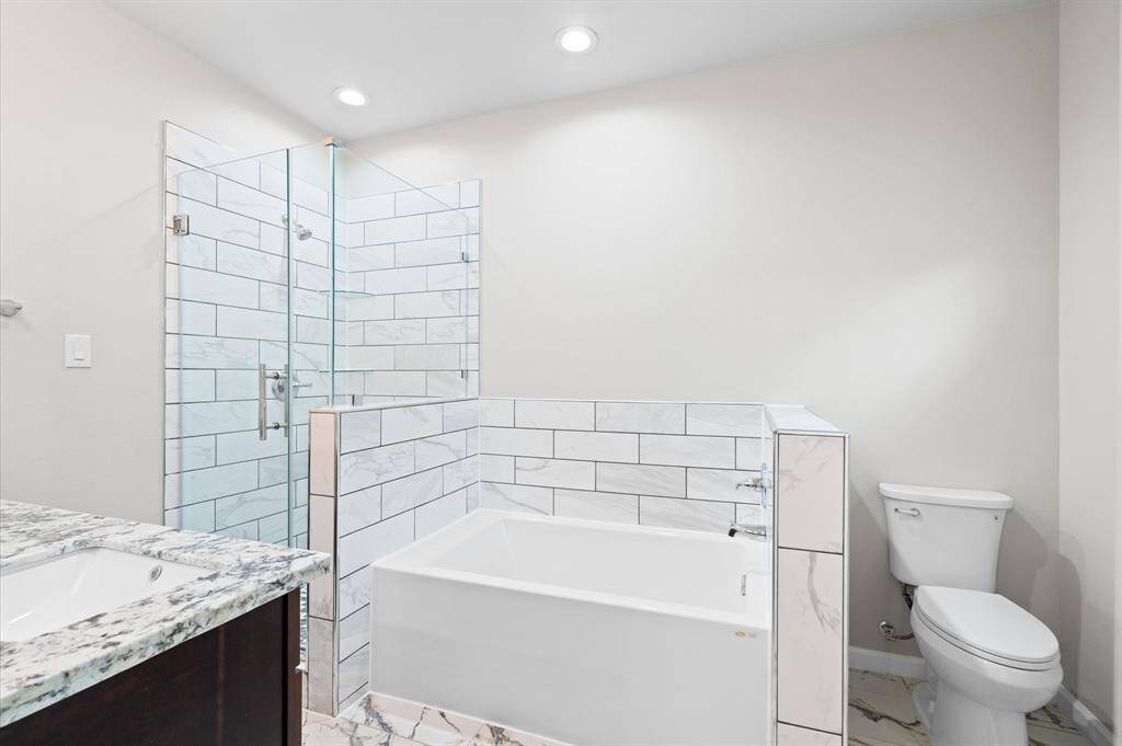 Primary bathroom with stand shower and tub.