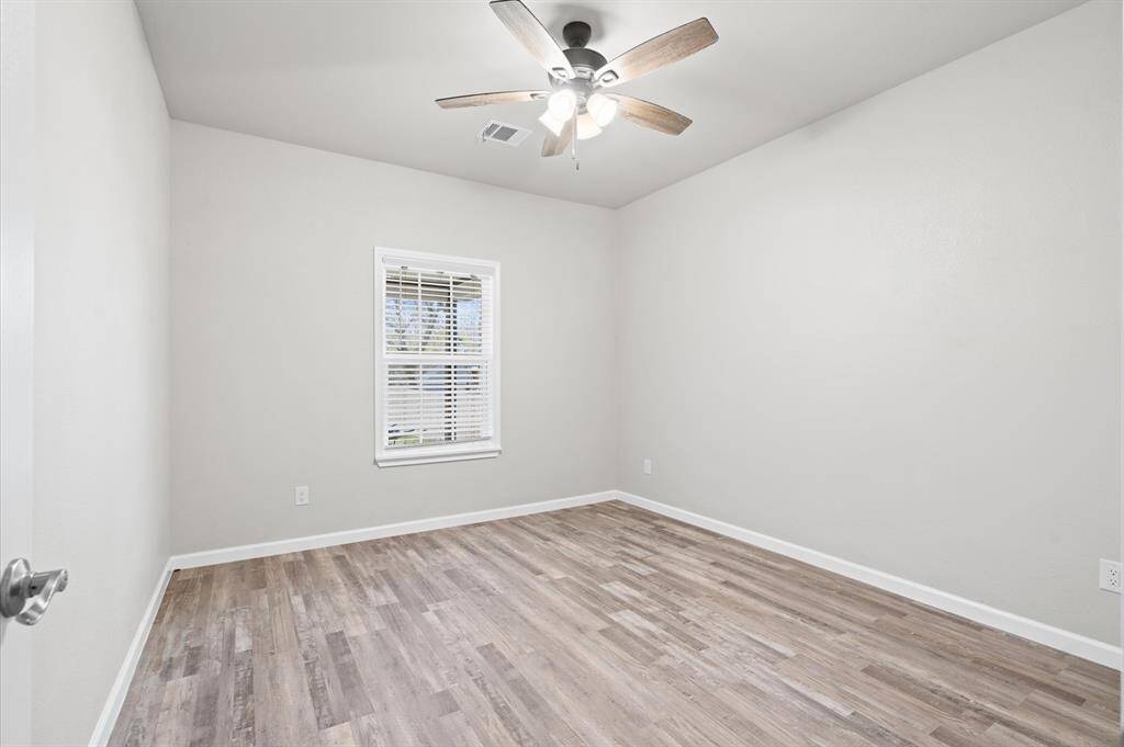 Secondary bedroom with a ceiling fan.