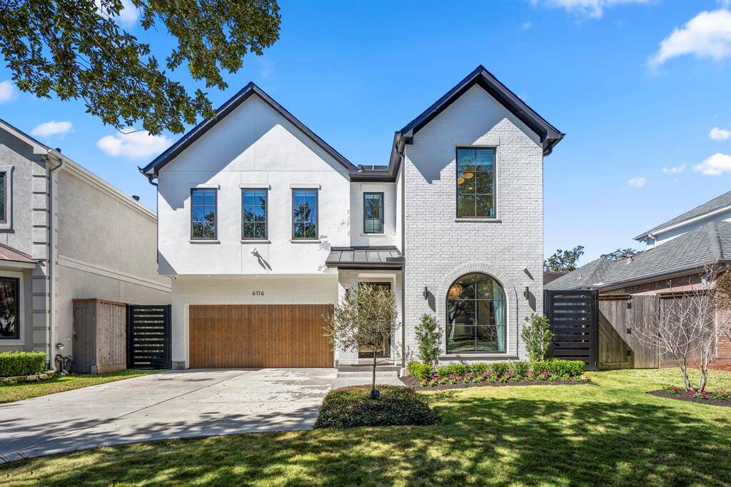 Another look at this home with stunning landscaping and a classic facade. Front door faces east.