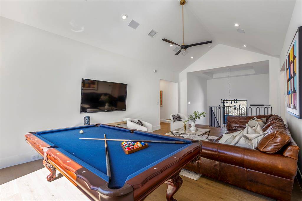 With vaulted ceilings, this game room features ample space to accommodate a pool table along with a sectional for movie watching with the family.